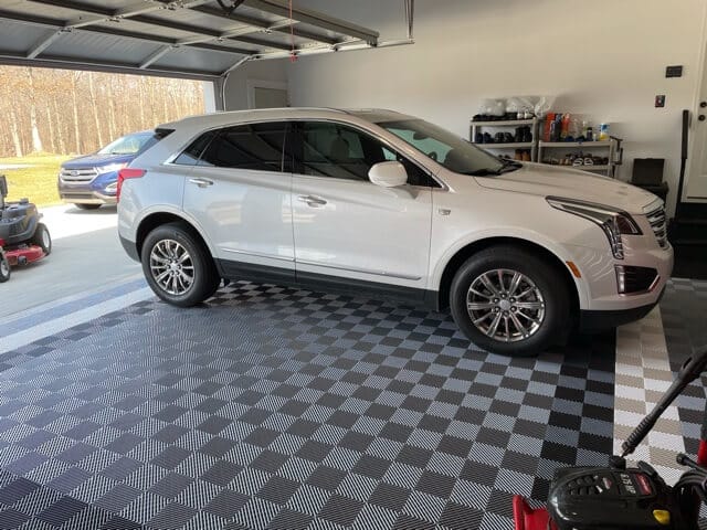 Grey garage floor tiles with white car