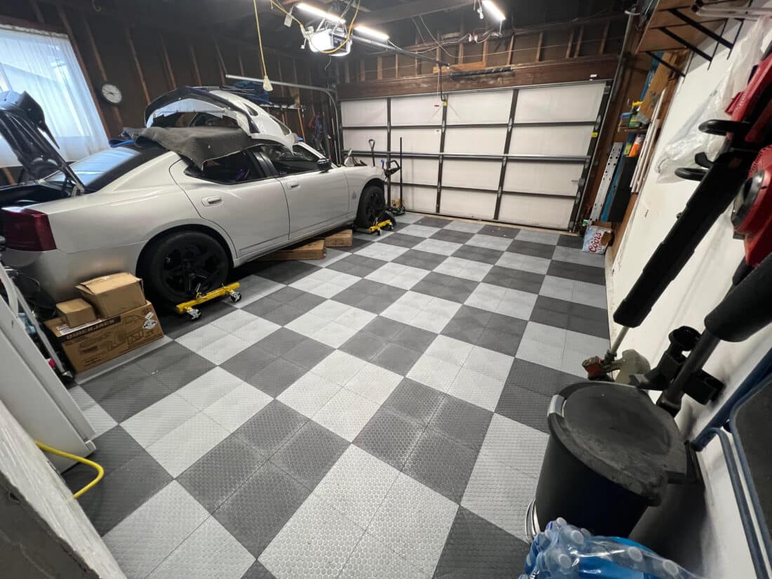 Silver Car and Checkerboard Garage Floor