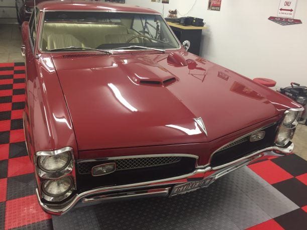 hood shot classic car on garage tile parking pad