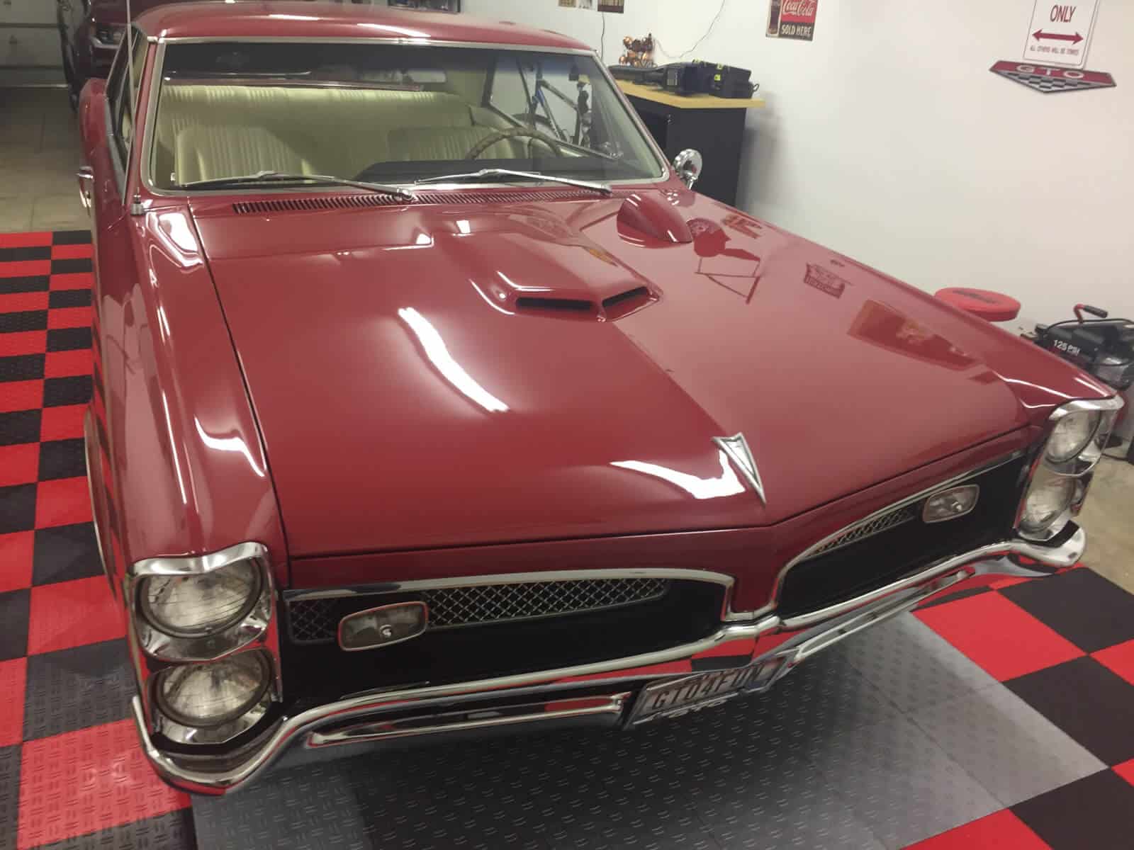 hood shot classic car on garage tile parking pad