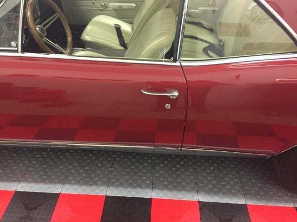 side view classic car on silver garage tile with red and black border