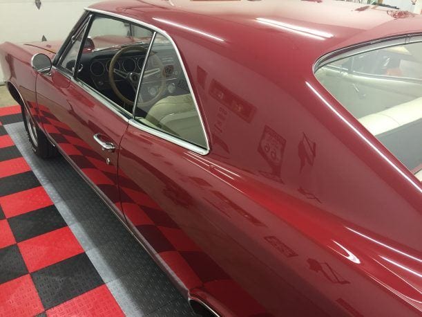 long view classic car on checkered garage floor tile
