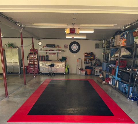 Garage with black tiles surrounded by red