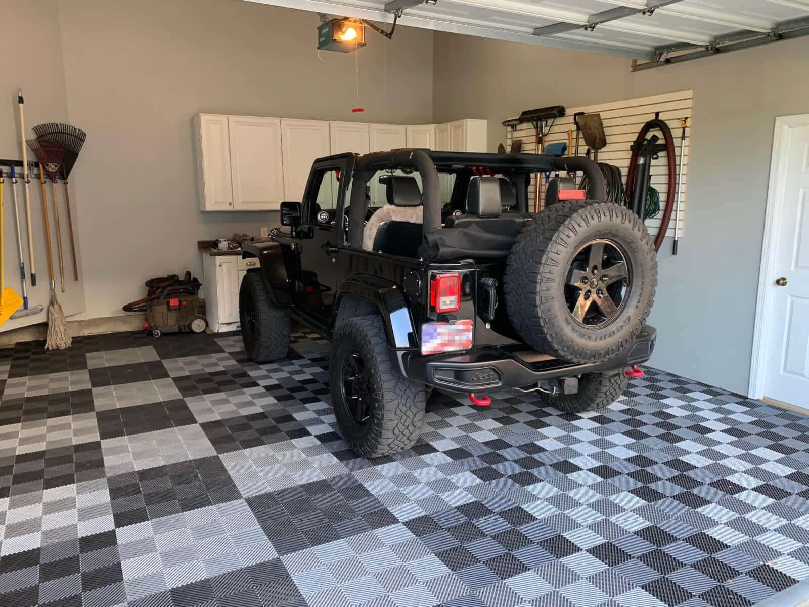 Free Flow Ribbed Garage Floor Tiles and Black Jeep