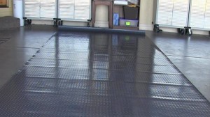 Rippled garage floor mat that will not lay flat