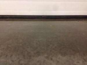 Water under garage door threshold