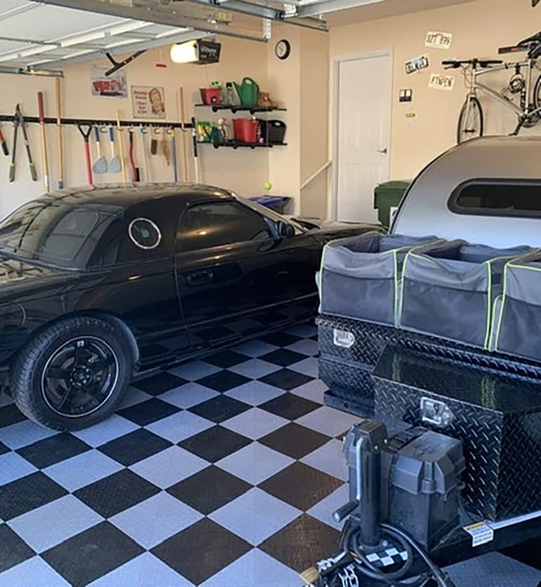 Black car on black and grey checkerboard tiles